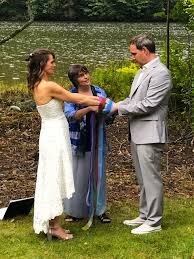 Each ribbon’s color brings a symbolic sentiment to this handfasting. (Photo by a guest of the couple)