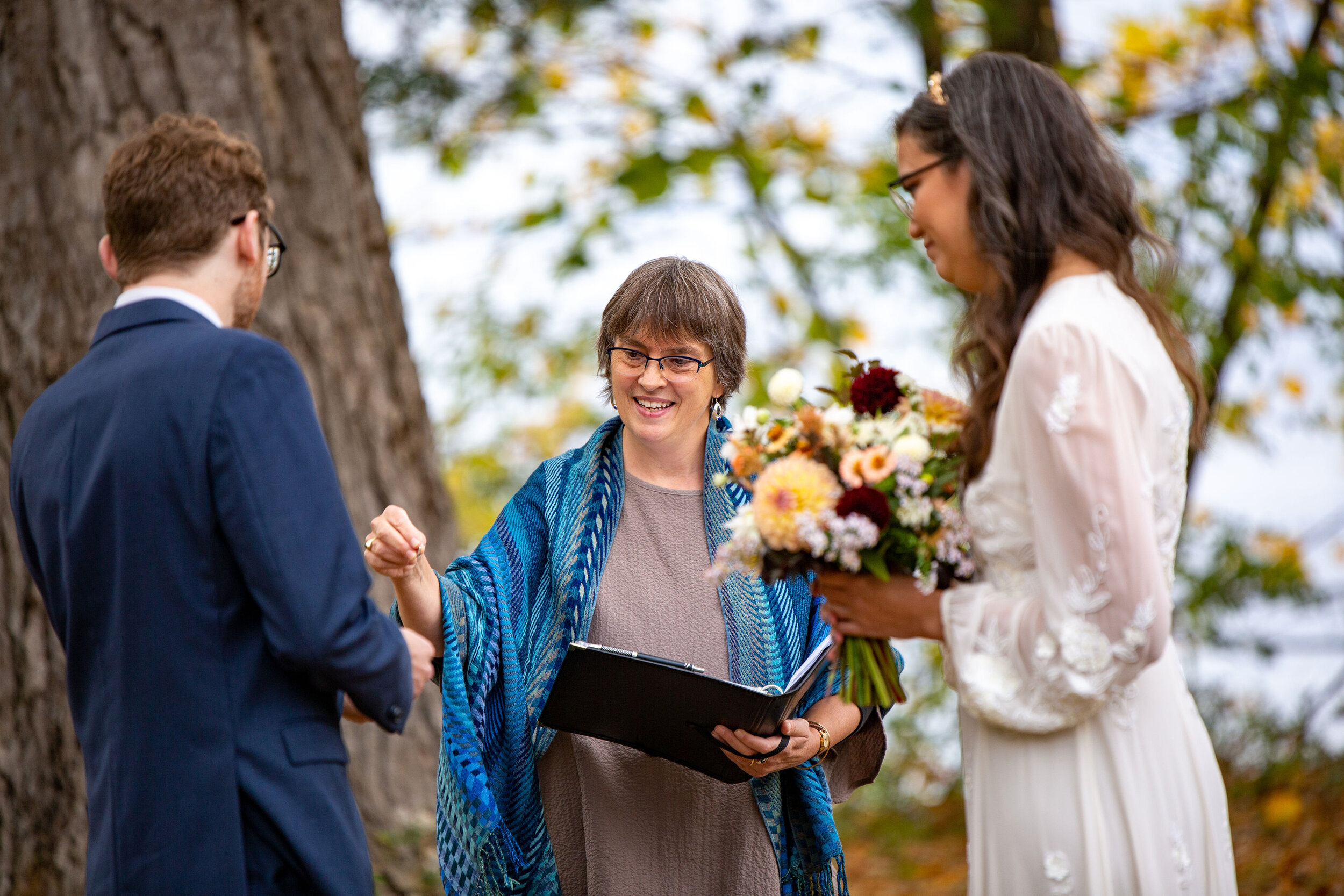 Handing him the ring, his symbolic gift to her. Image by Barbee of Owl’s Iris Photography.
